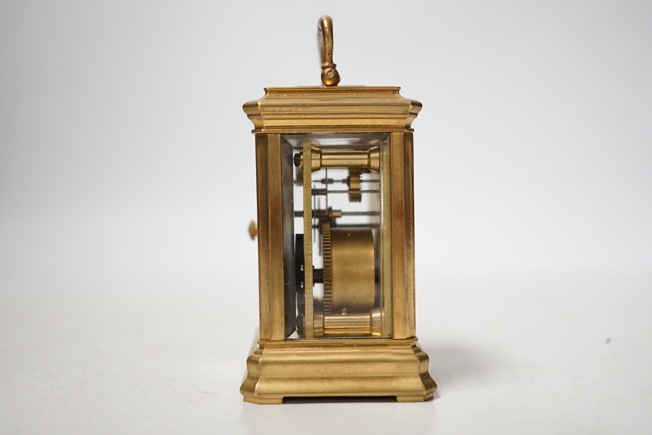 A small brass cased carriage timepiece with key, 9cm high